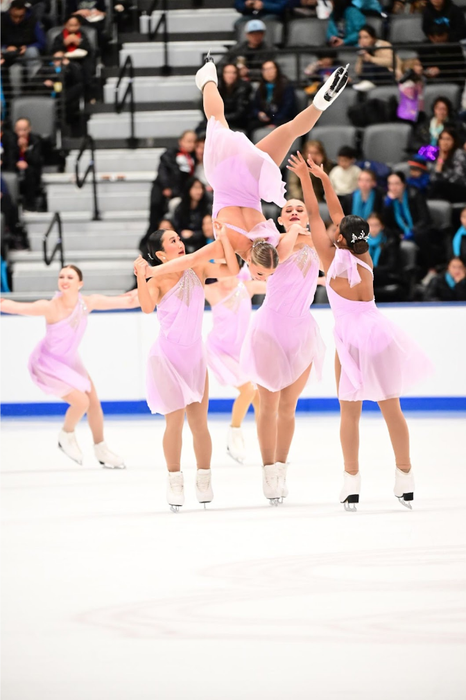 FLIPPING INTO FIRST A large component of the routine that can make or break the score are flips and lifts and each person has a different role. Chloe Ramcharan ‘26, far right, is responsible for pushing the flyer’s foot to provide momentum to complete the flip. “We had one time where the coaches decided to change the spot right before a competition and the flip ended up not working because they changed the spots and like the girl fell almost directly on her head,” Ramcharan said. “But that's when our strong team bond shows because the people next to her lifted her up and saved her.” 